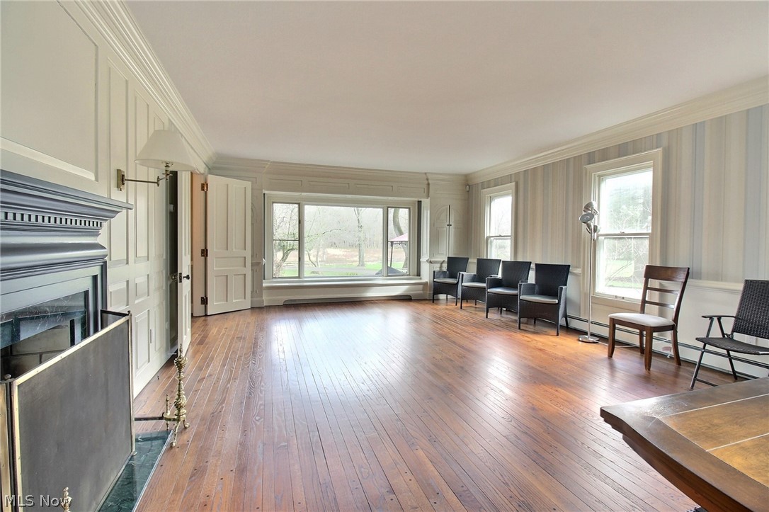 6715 Eagle Road Willoughby, OH 44094 - Photo 5 of 22 Living room featuring ornamental molding, a baseboard and dark hardwood flooring