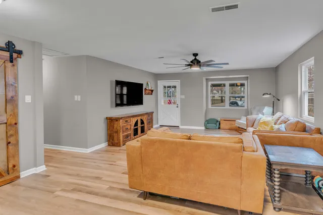 a room with furniture a flat screen tv and a table