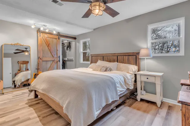 a bedroom with a bed and a chandelier