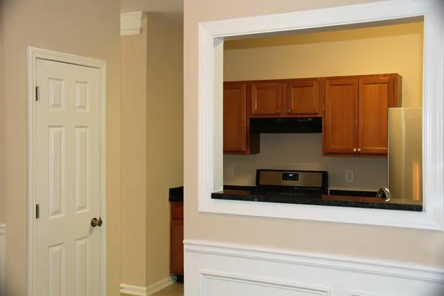 a kitchen with stainless steel appliances granite countertop a stove a refrigerator and a microwave