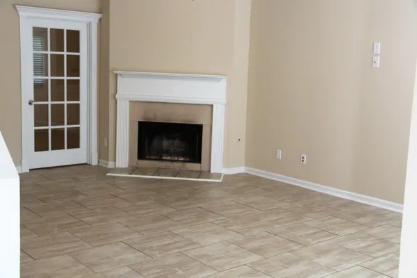 a view of an empty room with a fireplace