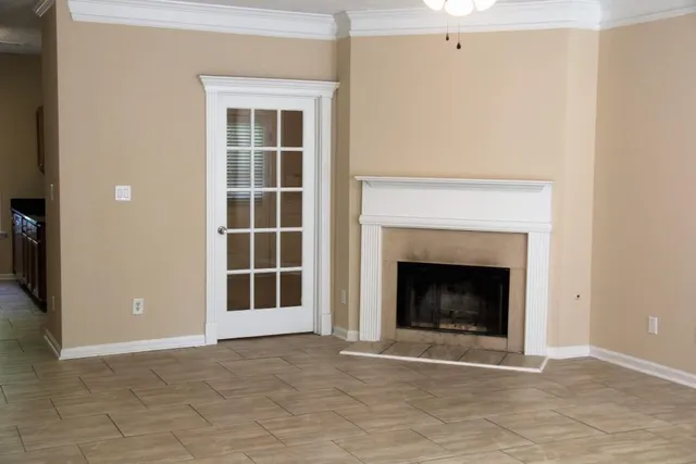 a living room with a fireplace and a rug