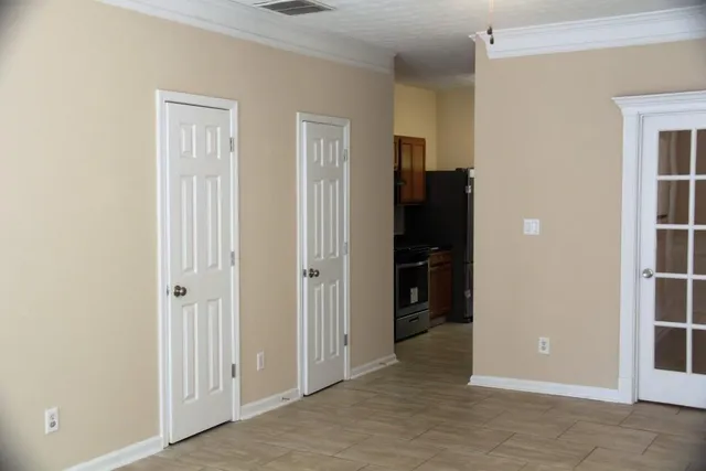 an empty room with closet and a bathroom