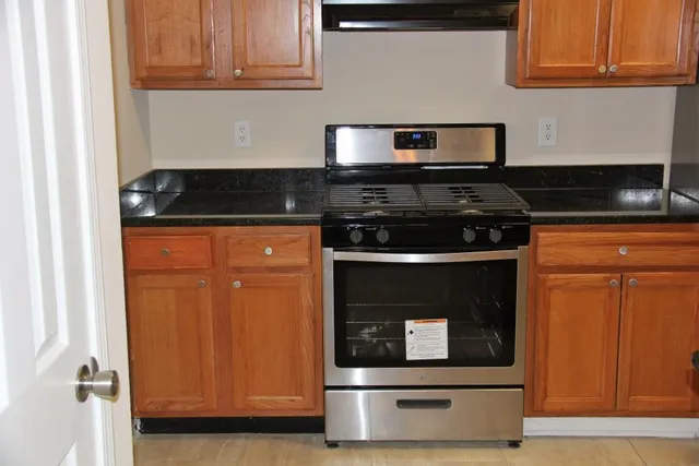 a kitchen with stainless steel appliances granite countertop a stove and a microwave