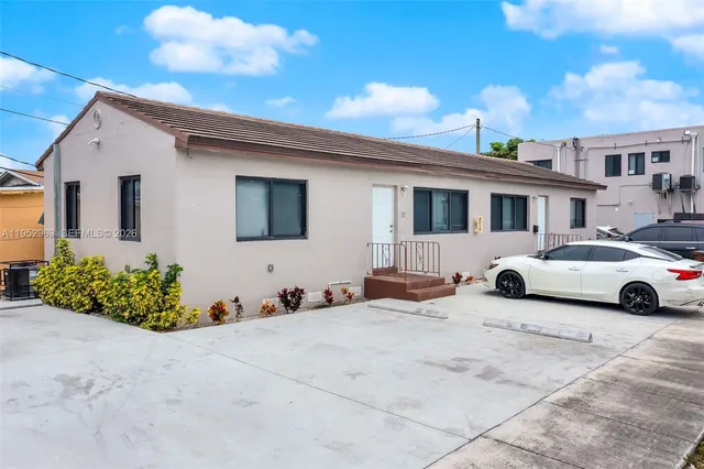 a view of a car park in front of house