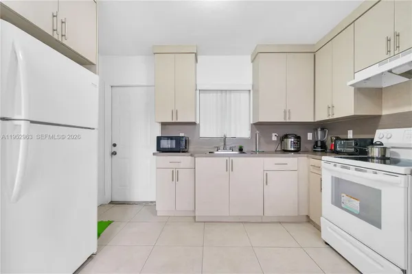 a kitchen with cabinets and appliances