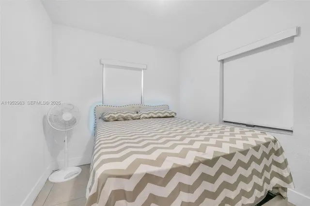 a bedroom with a bed and a mirror