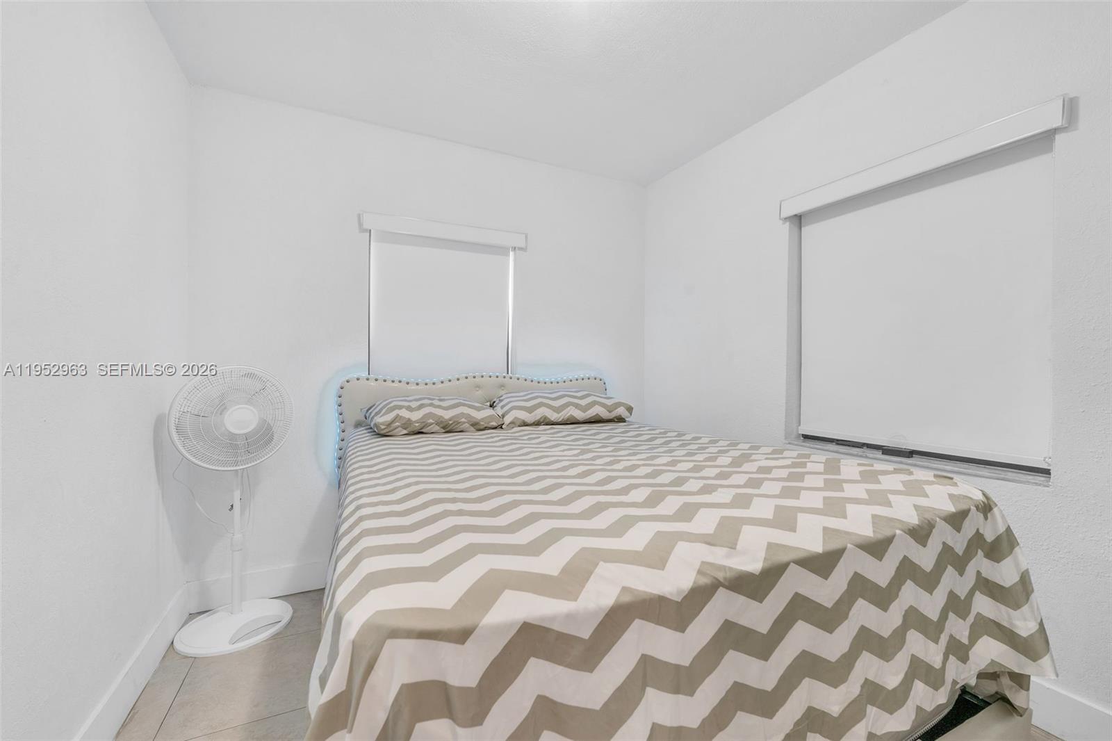 9 West 16th Street, Unit 9 Hialeah, FL 33010 - Photo 7 of 9 a bedroom with a bed and a mirror