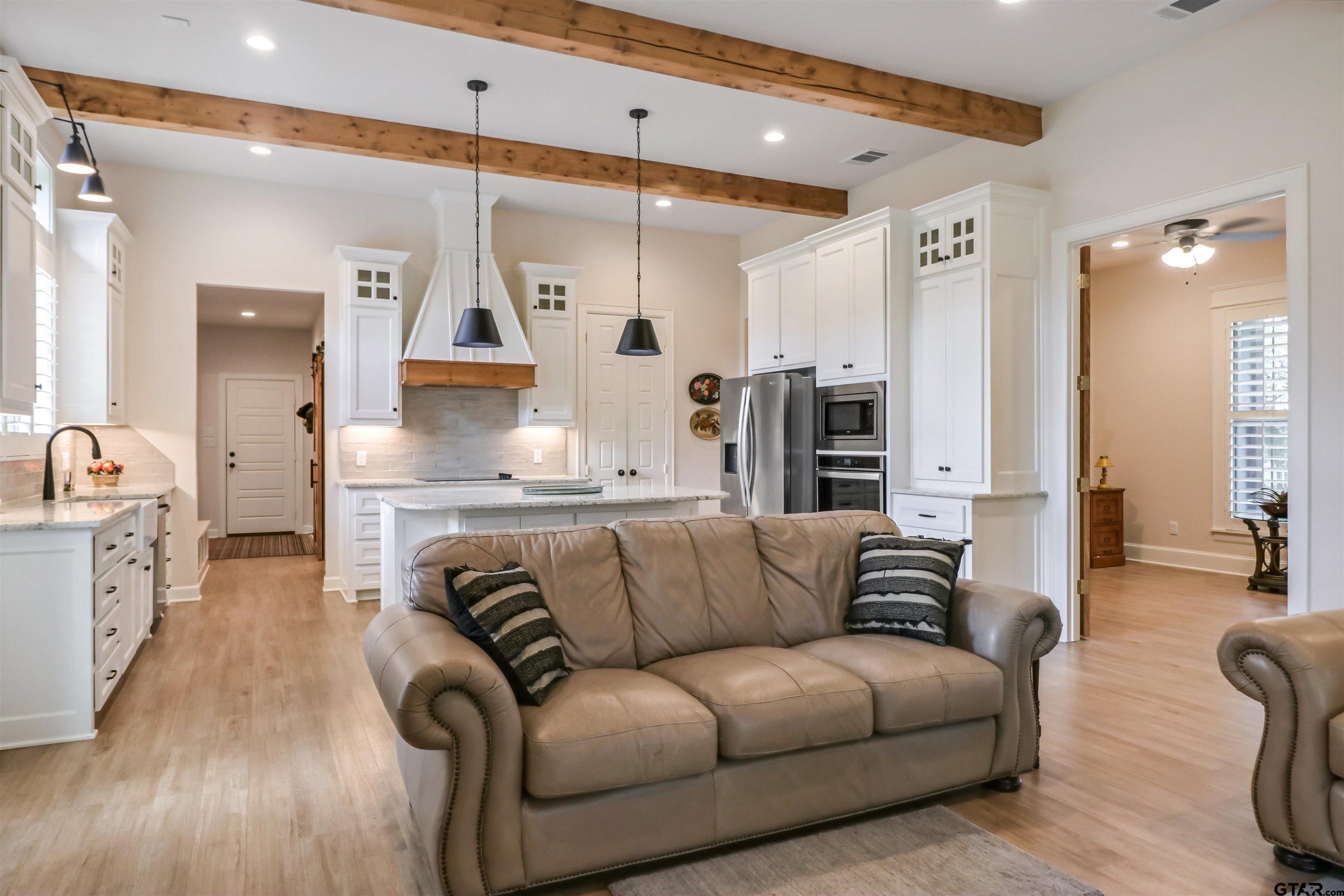15733 County Road 1104 Flint, TX 75762 - Photo 11 of 32 a living room with furniture kitchen view and a wooden floor