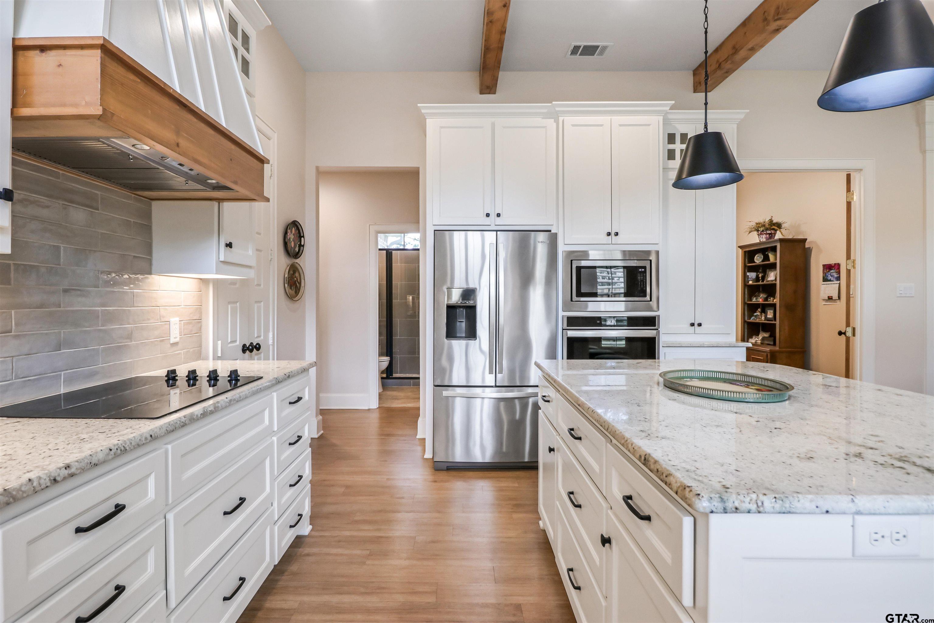 15733 County Road 1104 Flint, TX 75762 - Photo 15 of 32 a kitchen with stainless steel appliances granite countertop a sink and a refrigerator
