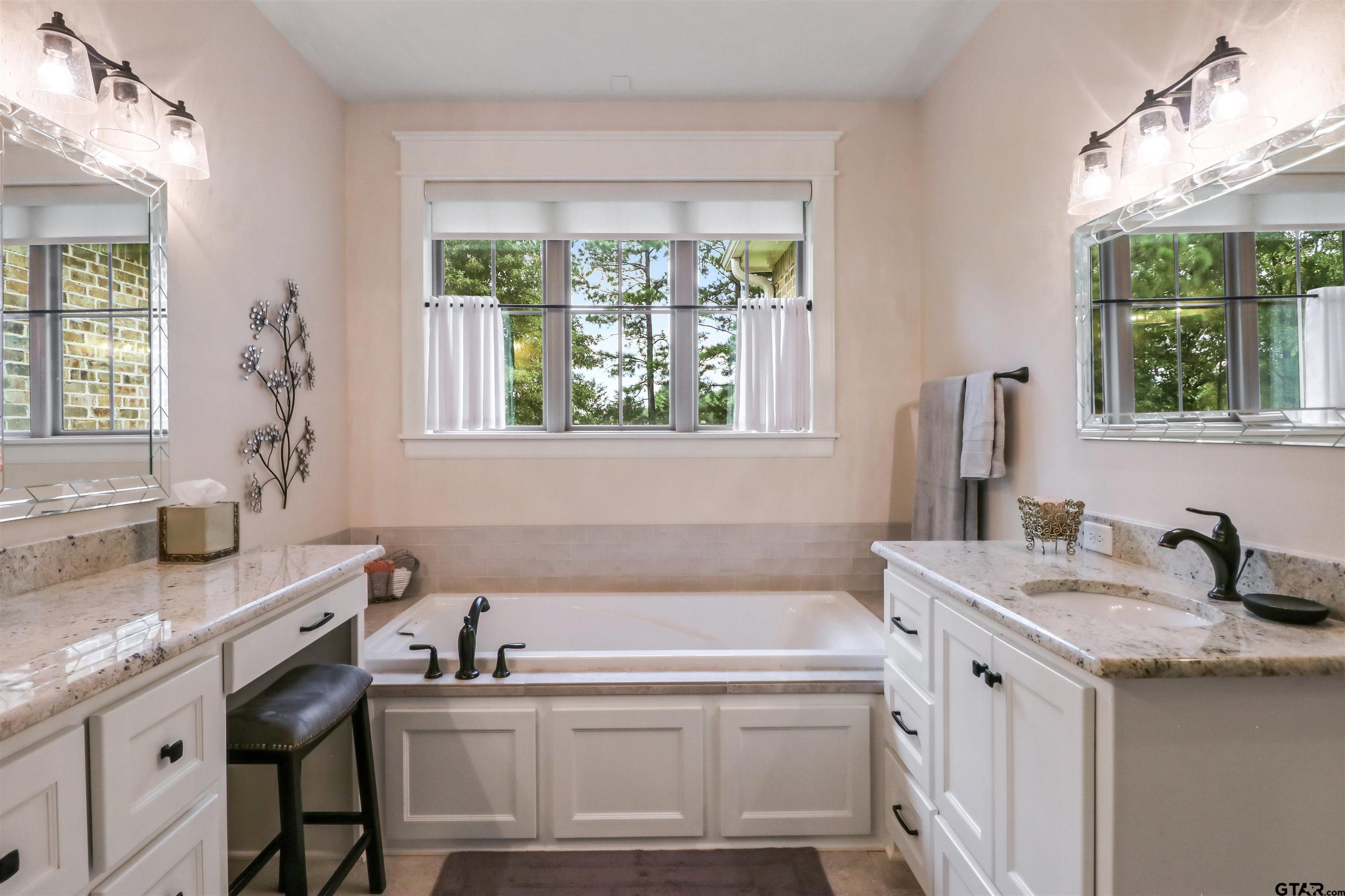 15733 County Road 1104 Flint, TX 75762 - Photo 21 of 32 a bathroom with a granite countertop sink and a window