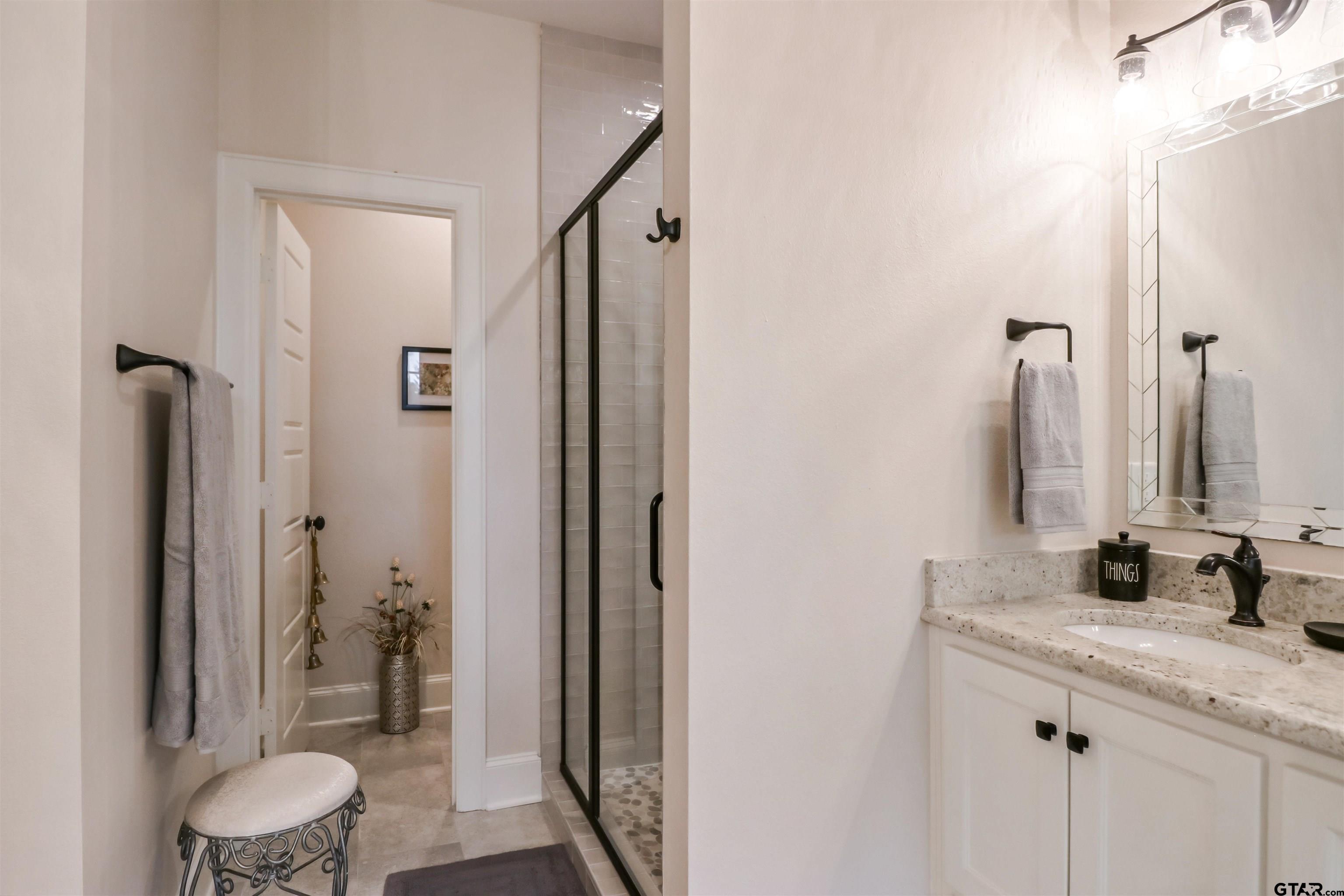 15733 County Road 1104 Flint, TX 75762 - Photo 22 of 32 a bathroom with a granite countertop sink toilet and shower