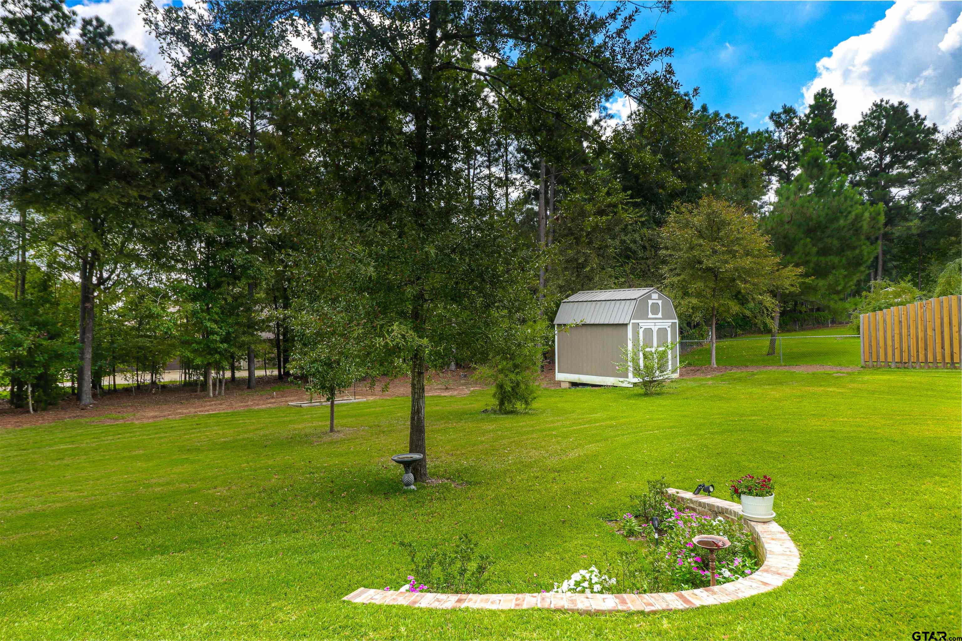 15733 County Road 1104 Flint, TX 75762 - Photo 29 of 32 a backyard of a house with lots of green space