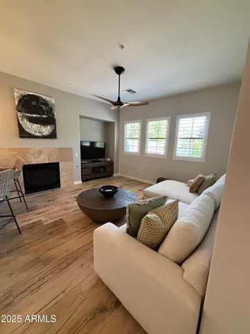 a living room with furniture flat screen tv and a fireplace