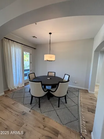 a dining room with furniture and window