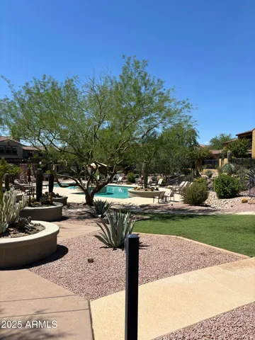 a view of a backyard and swimming pool