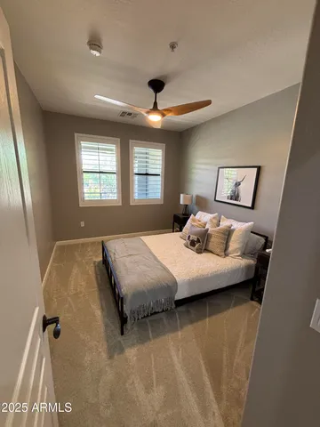 a bedroom with a bed and a large window