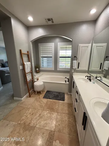 a bathroom with a sink a toilet a mirror and window