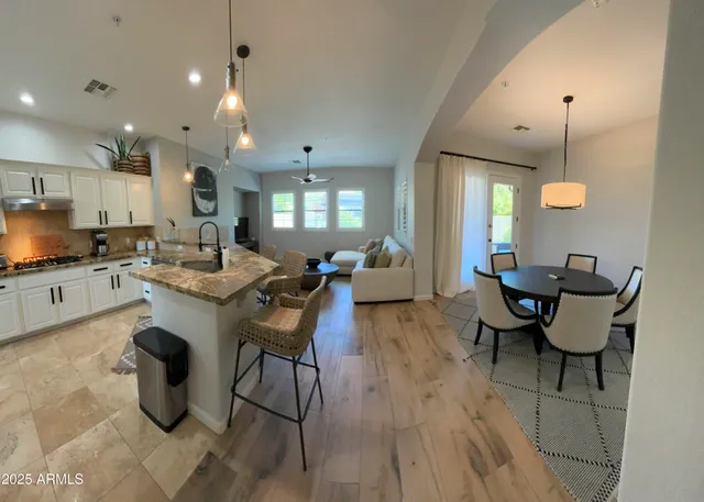 a living room with lots of furniture and kitchen view