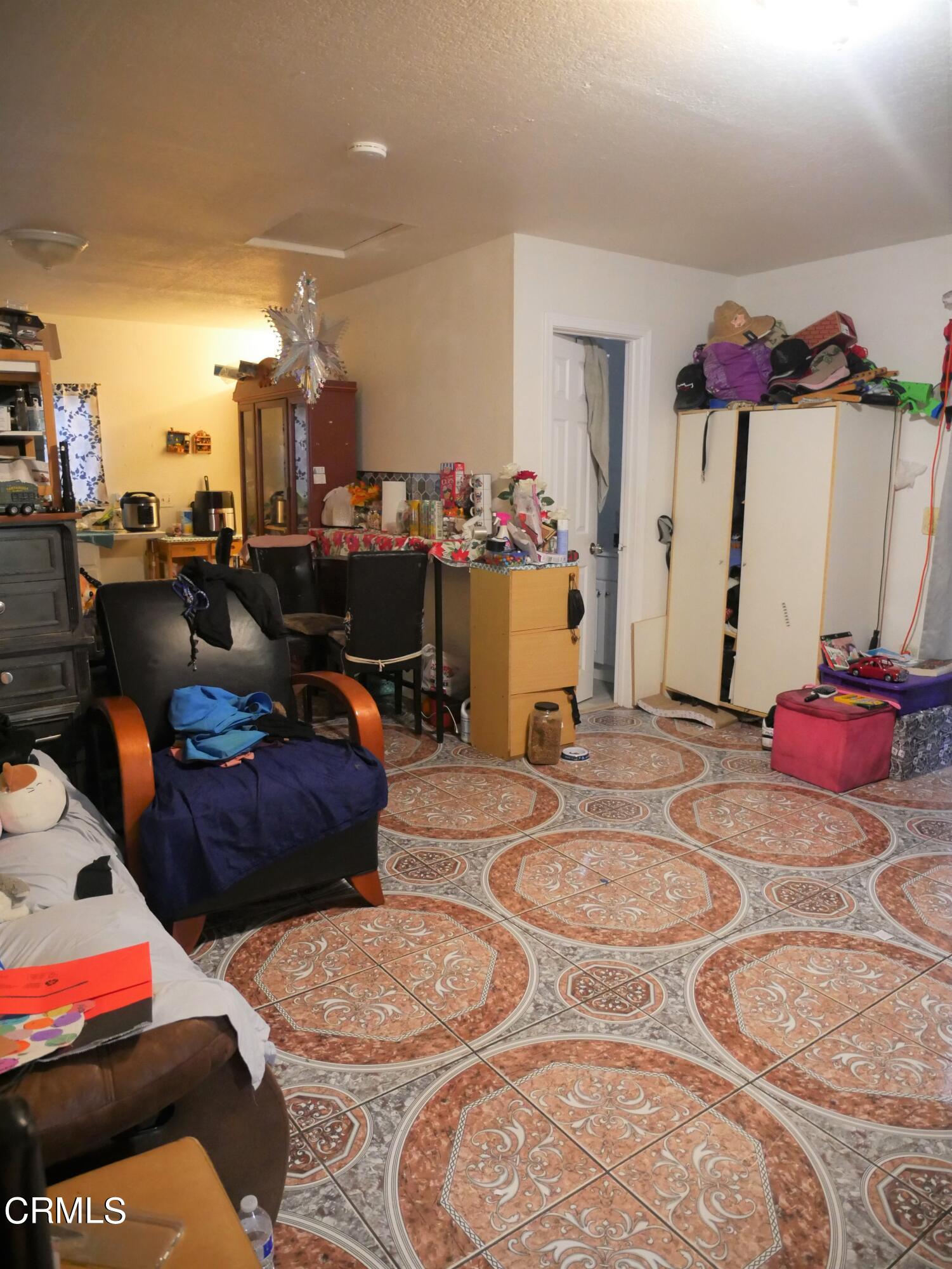 640 Tamarac Street Oxnard, CA 93033 - Photo 40 of 54 a living room with furniture a rug and a chandelier