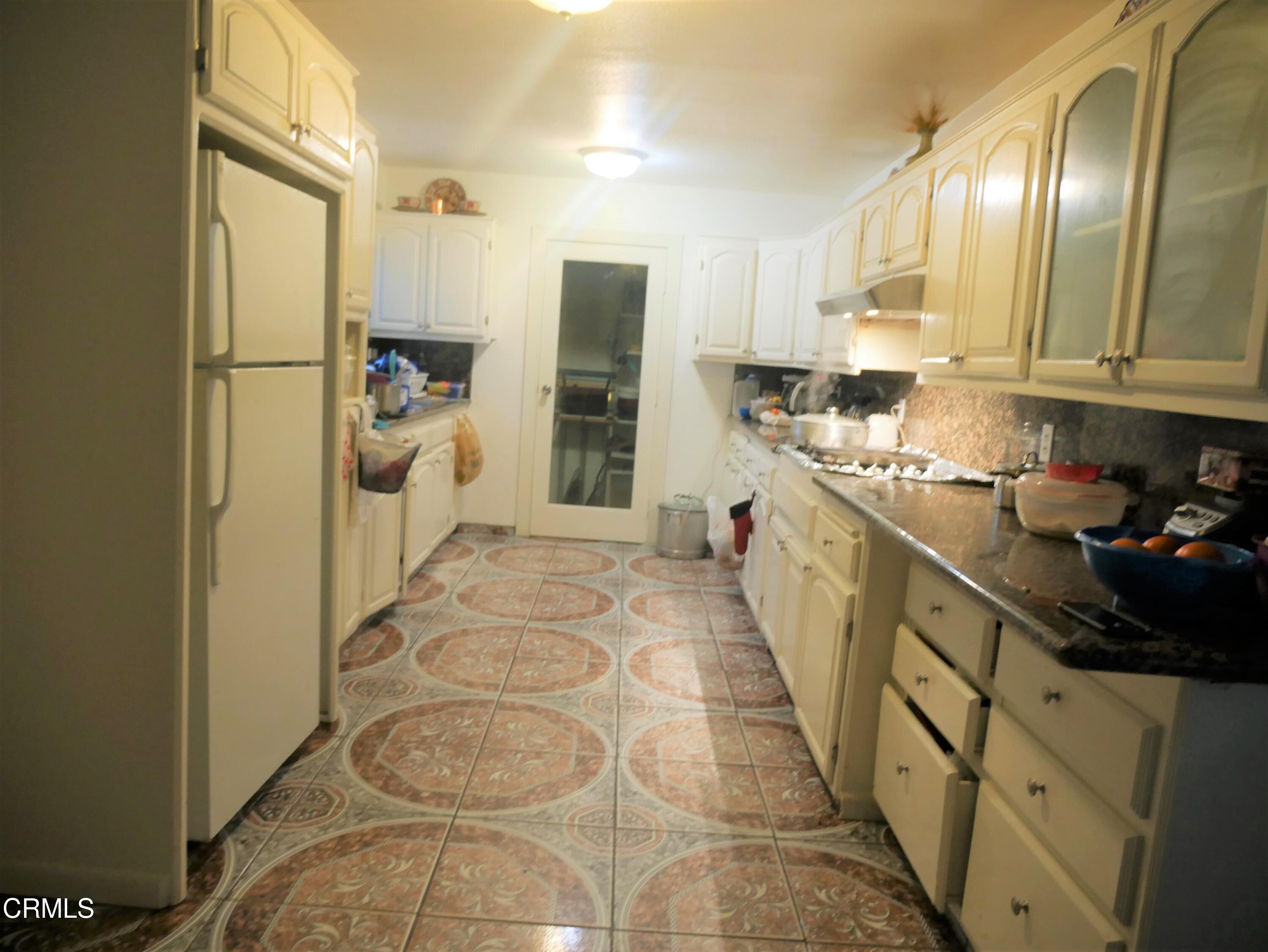 640 Tamarac Street Oxnard, CA 93033 - Photo 9 of 54 a kitchen with stainless steel appliances granite countertop a refrigerator a stove and a sink
