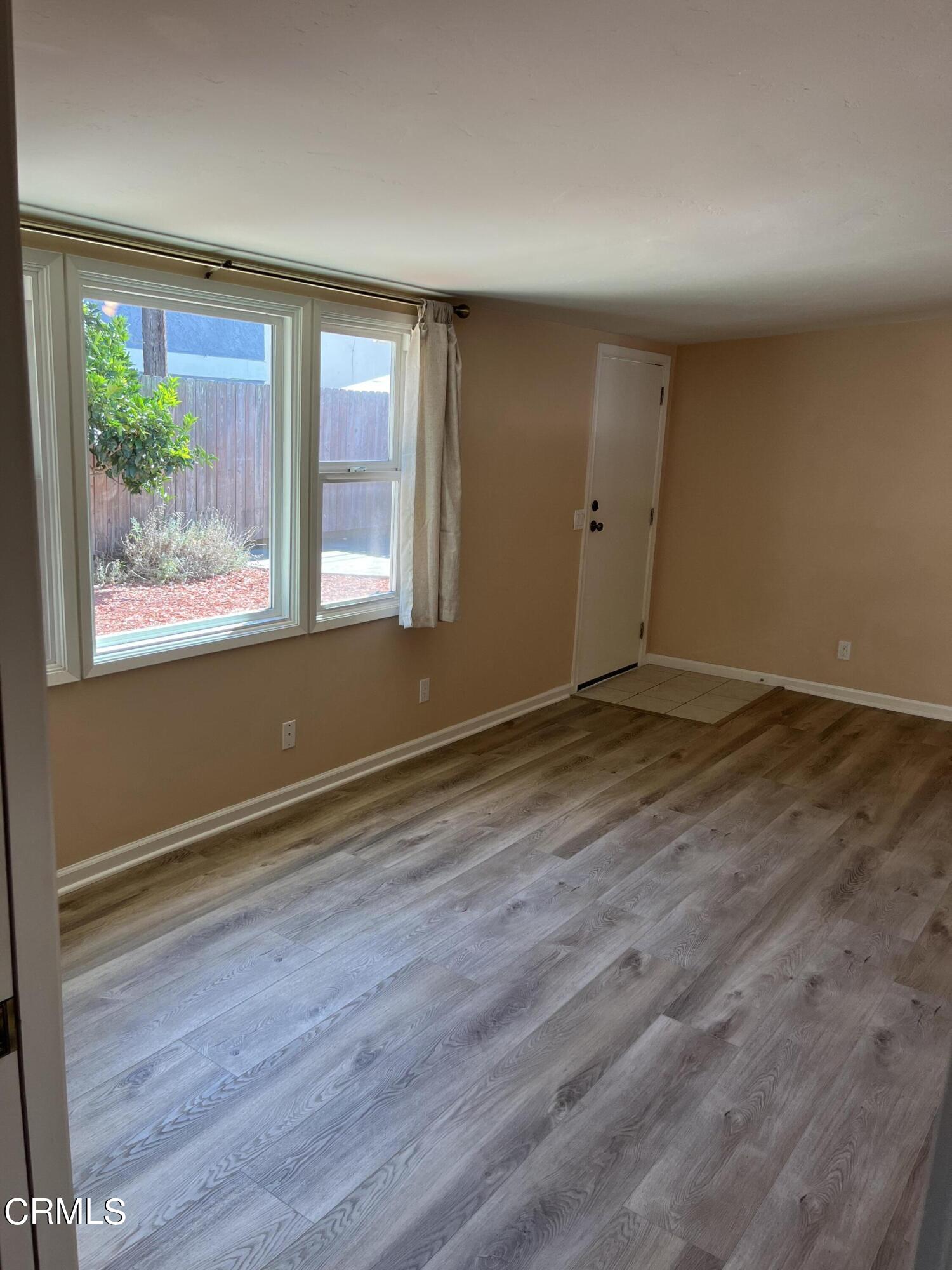 304 Cahuenga Drive Oxnard, CA 93035 - Photo 3 of 9 a view of an empty room with wooden floor and a window
