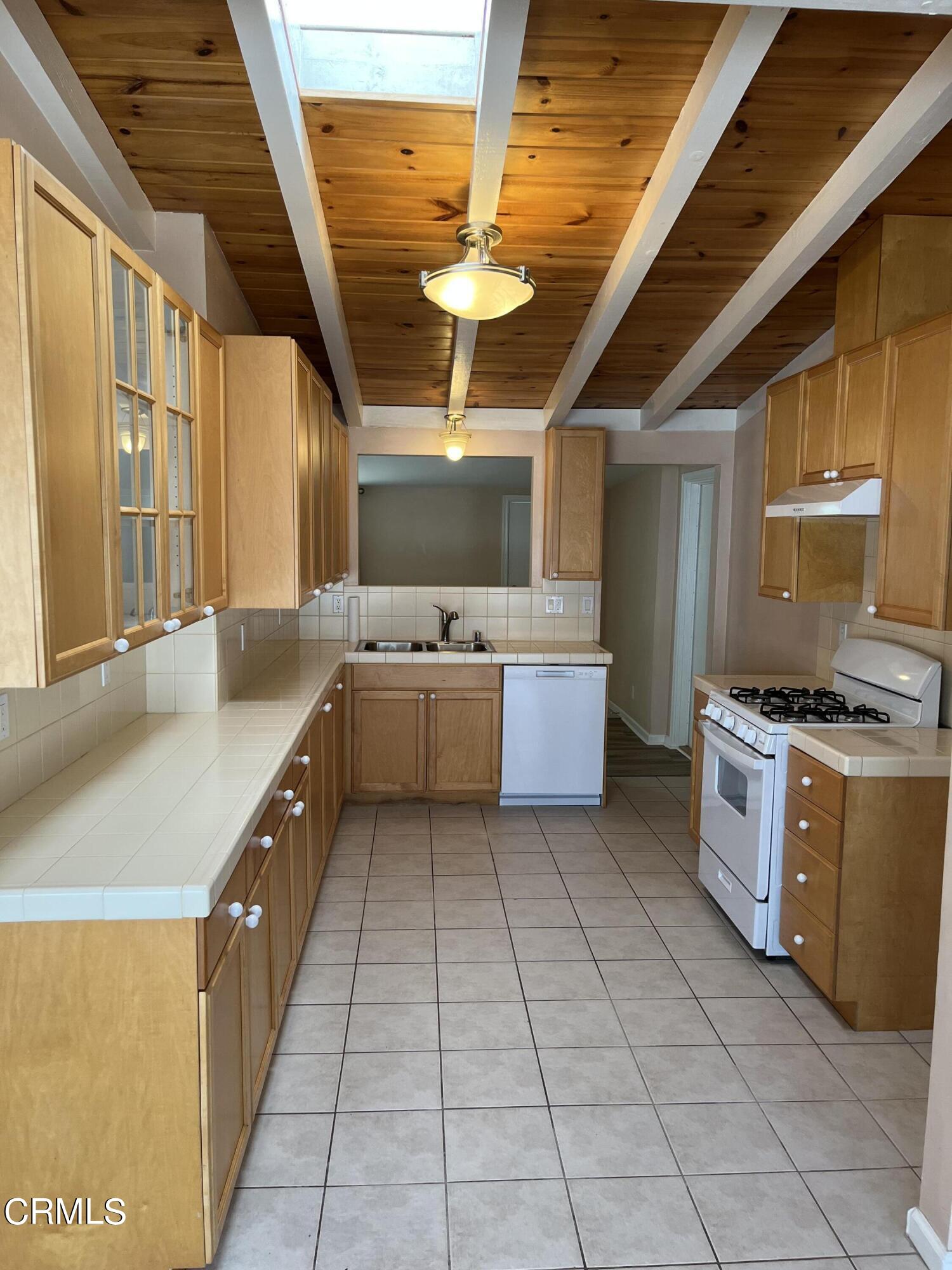 304 Cahuenga Drive Oxnard, CA 93035 - Photo 5 of 9 a kitchen with stainless steel appliances granite countertop a sink and cabinets