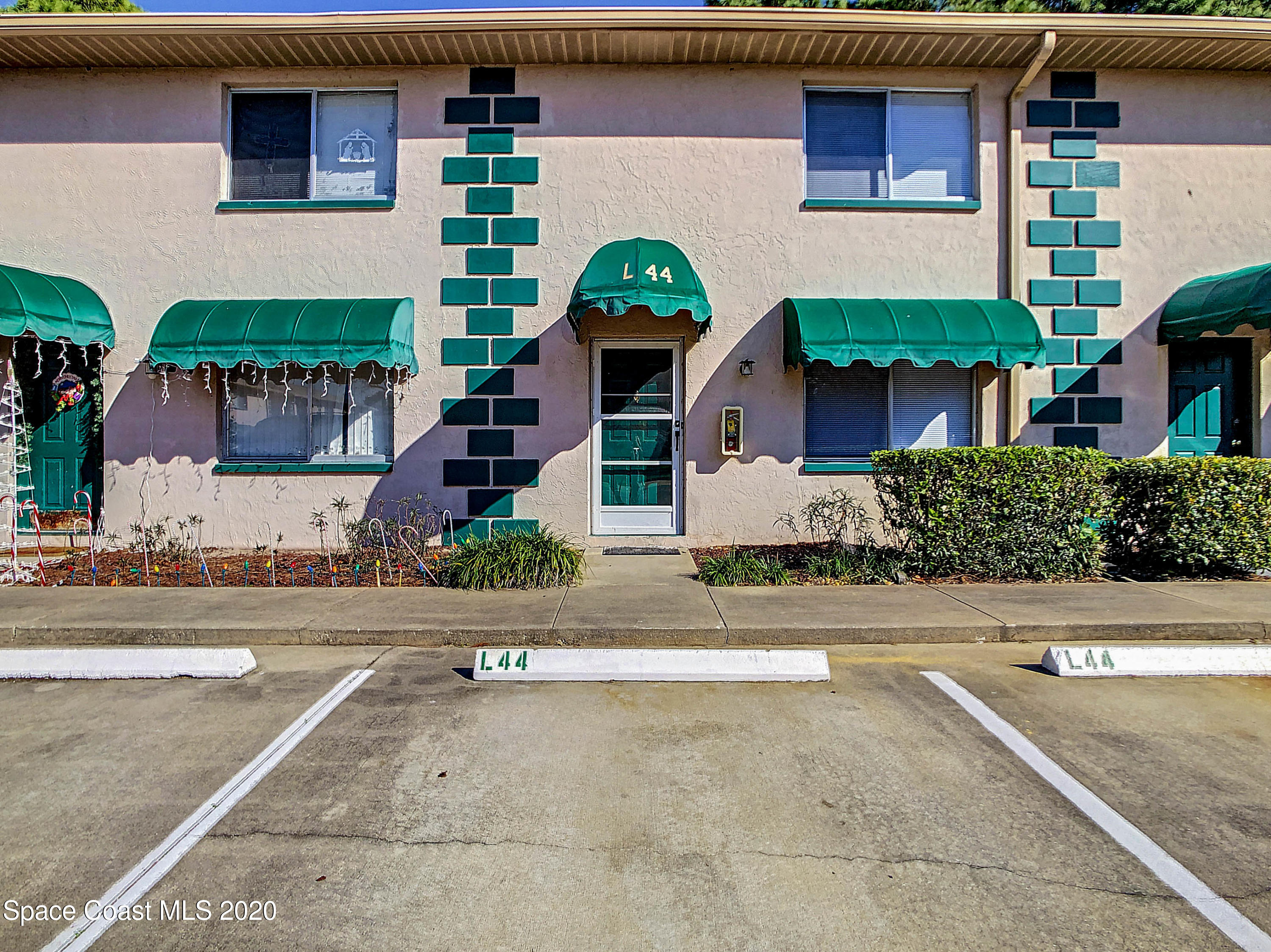 1882 Murrell Road, Unit 44 Rockledge, FL 32955 - Photo 1 of 27 front view of a house with potted plants