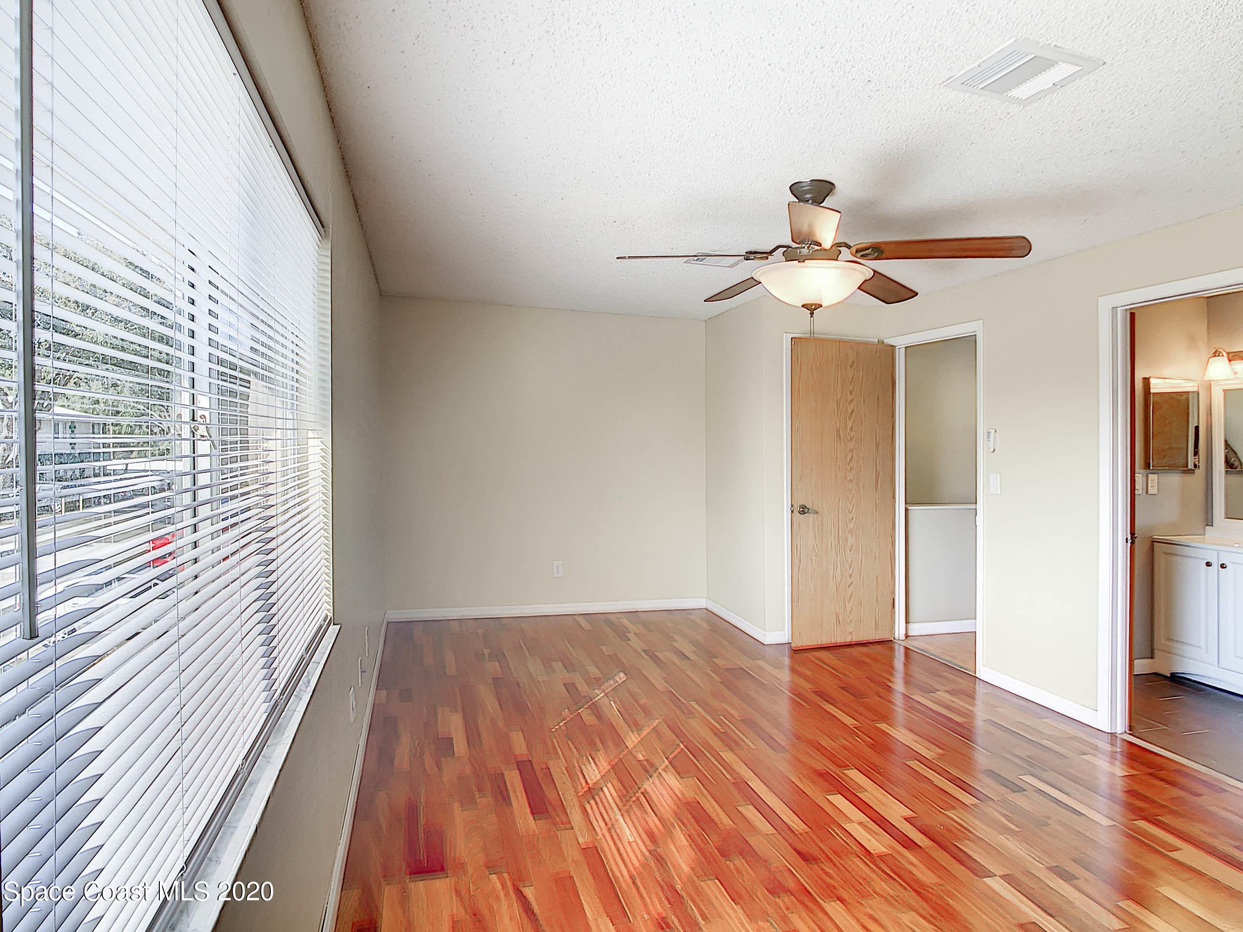 1882 Murrell Road, Unit 44 Rockledge, FL 32955 - Photo 11 of 27 a view of a room with wooden floor and a ceiling fan
