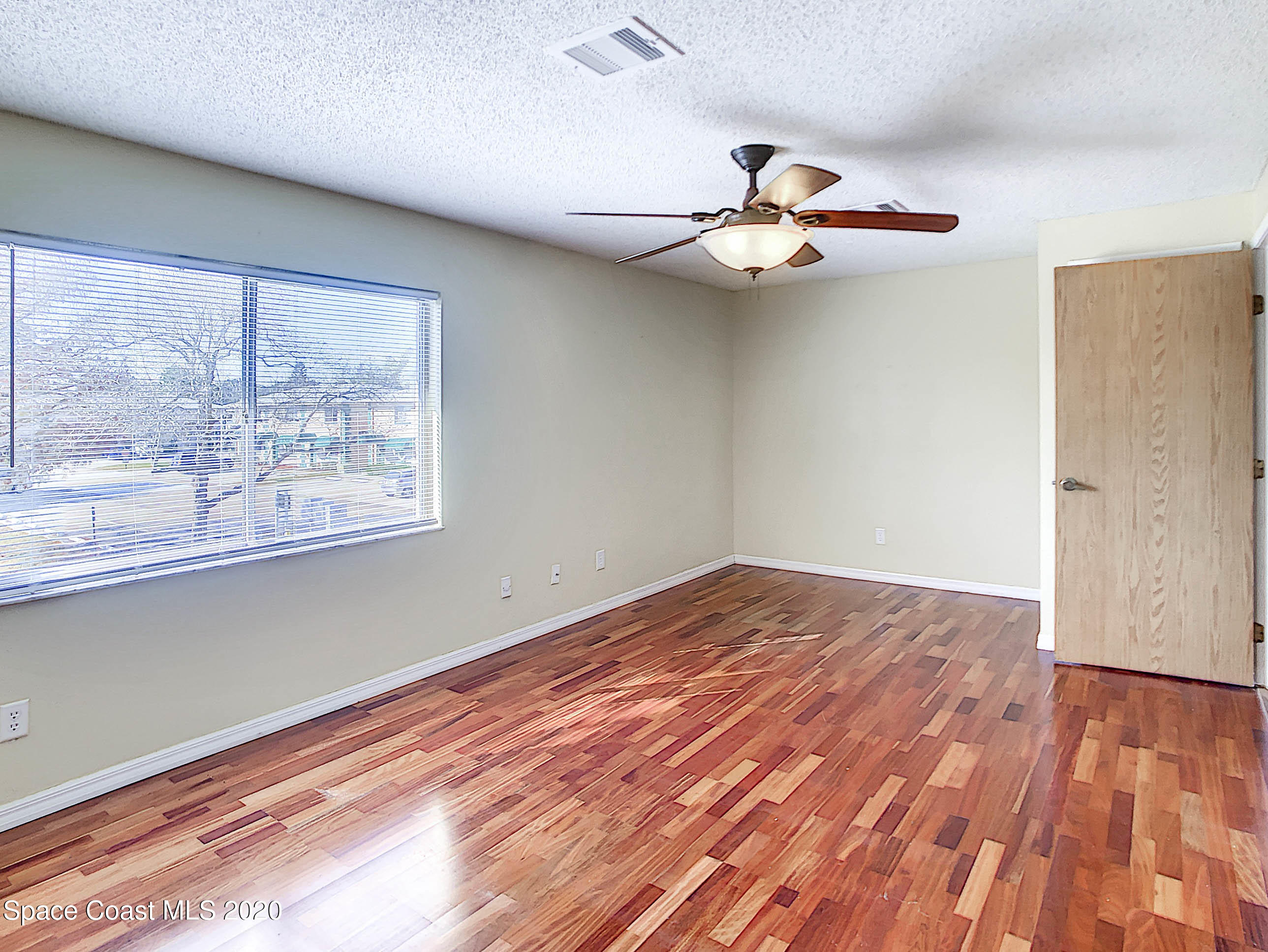 1882 Murrell Road, Unit 44 Rockledge, FL 32955 - Photo 12 of 27 a view of empty room with wooden floor and fan