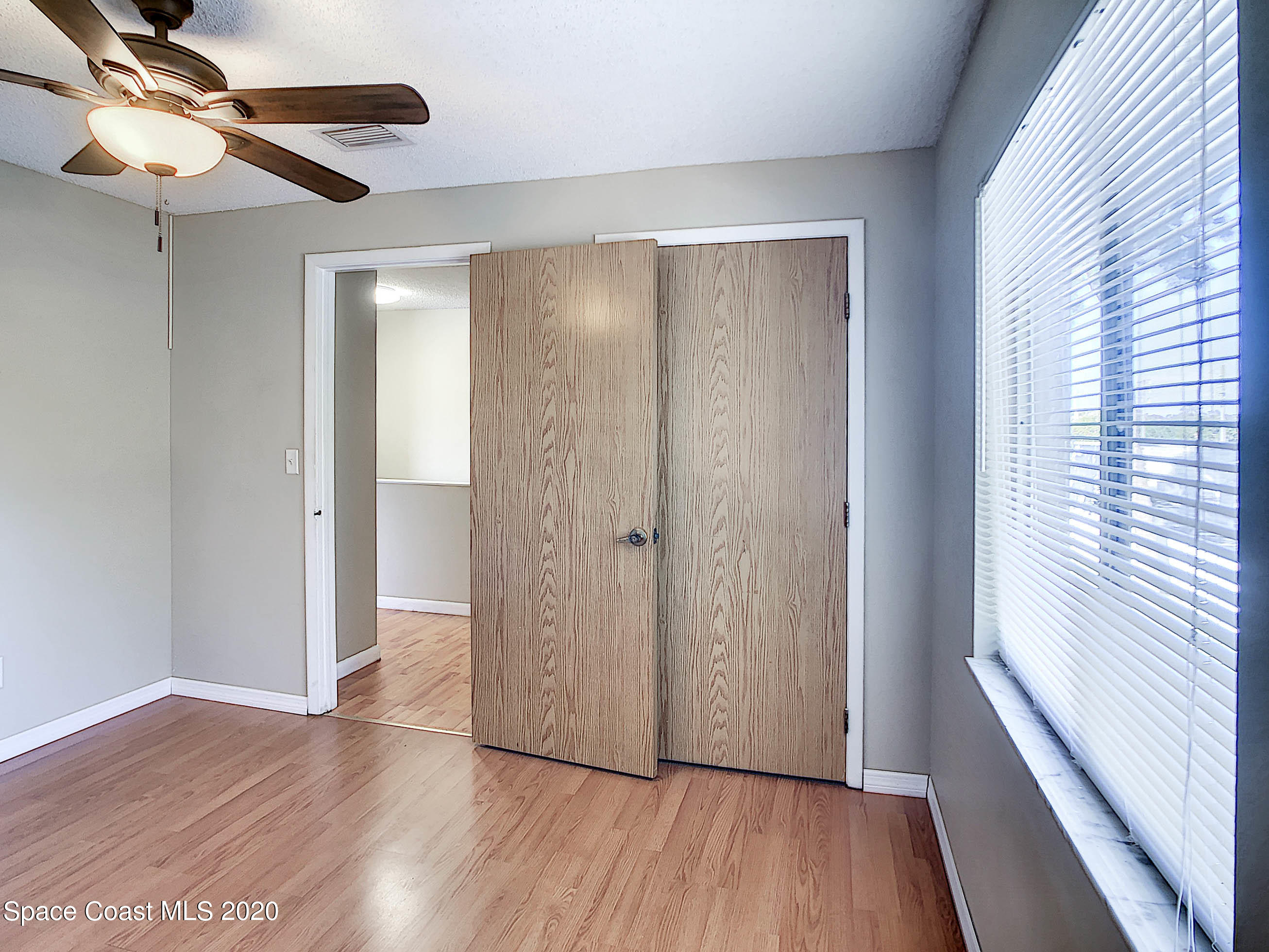 1882 Murrell Road, Unit 44 Rockledge, FL 32955 - Photo 17 of 27 a view of a hallway with wooden floor and closet area