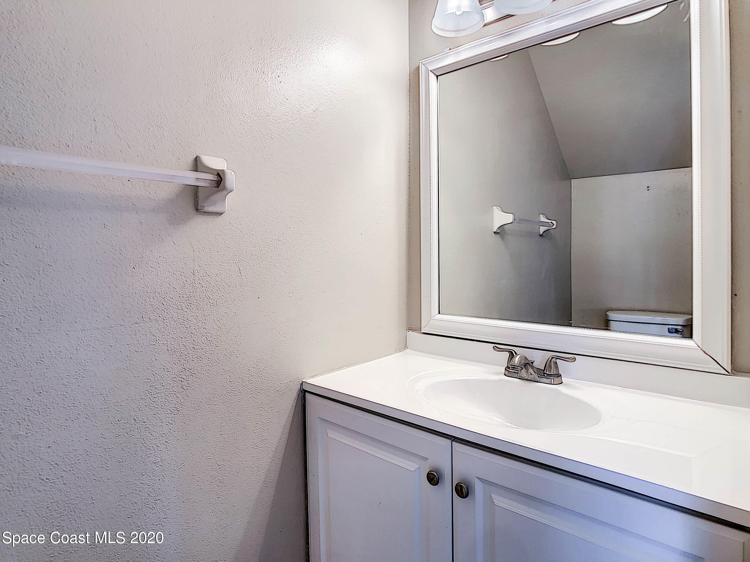 1882 Murrell Road, Unit 44 Rockledge, FL 32955 - Photo 20 of 27 a bathroom with a sink and mirror