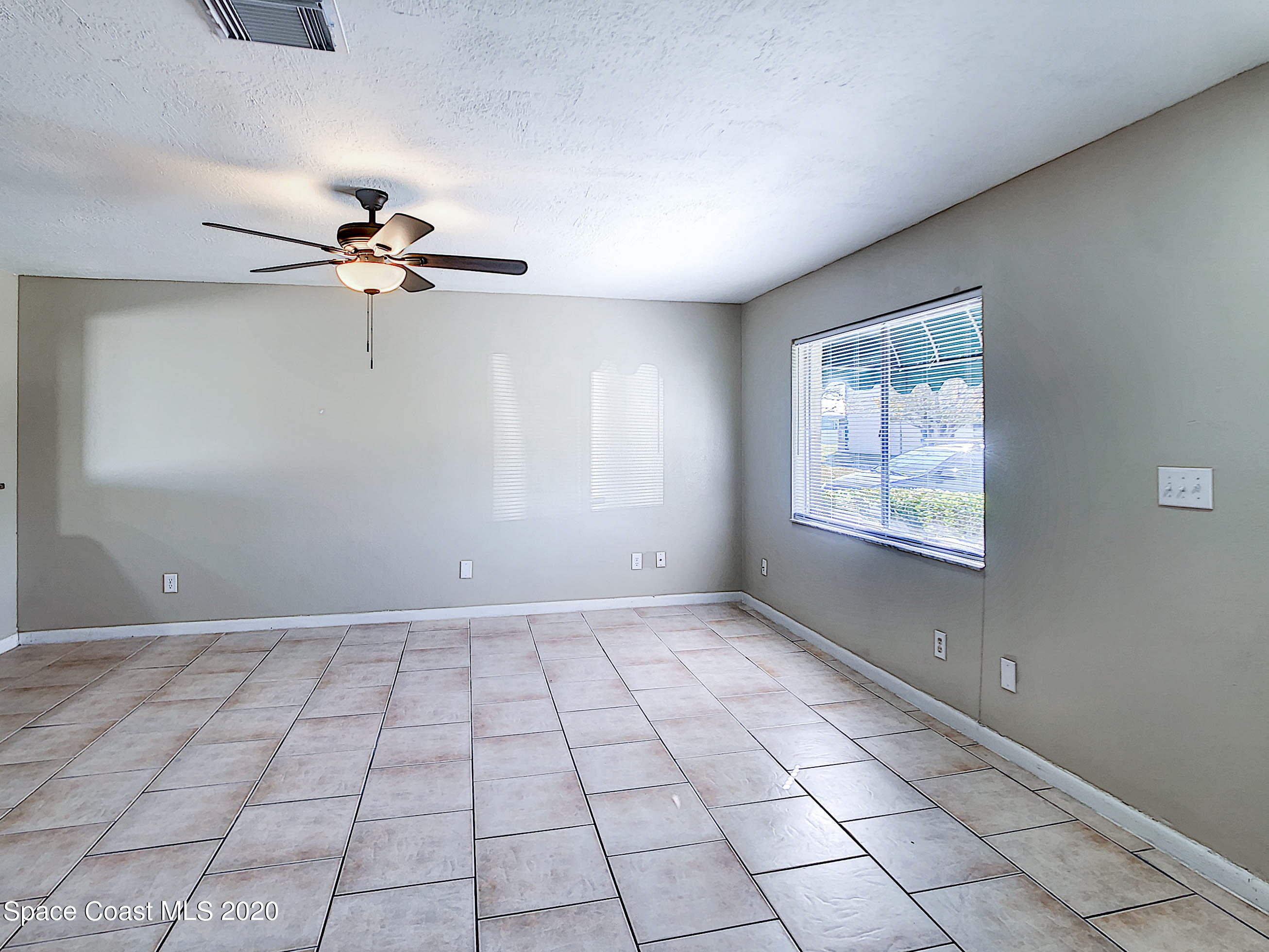 1882 Murrell Road, Unit 44 Rockledge, FL 32955 - Photo 4 of 27 a view of an empty room with a window