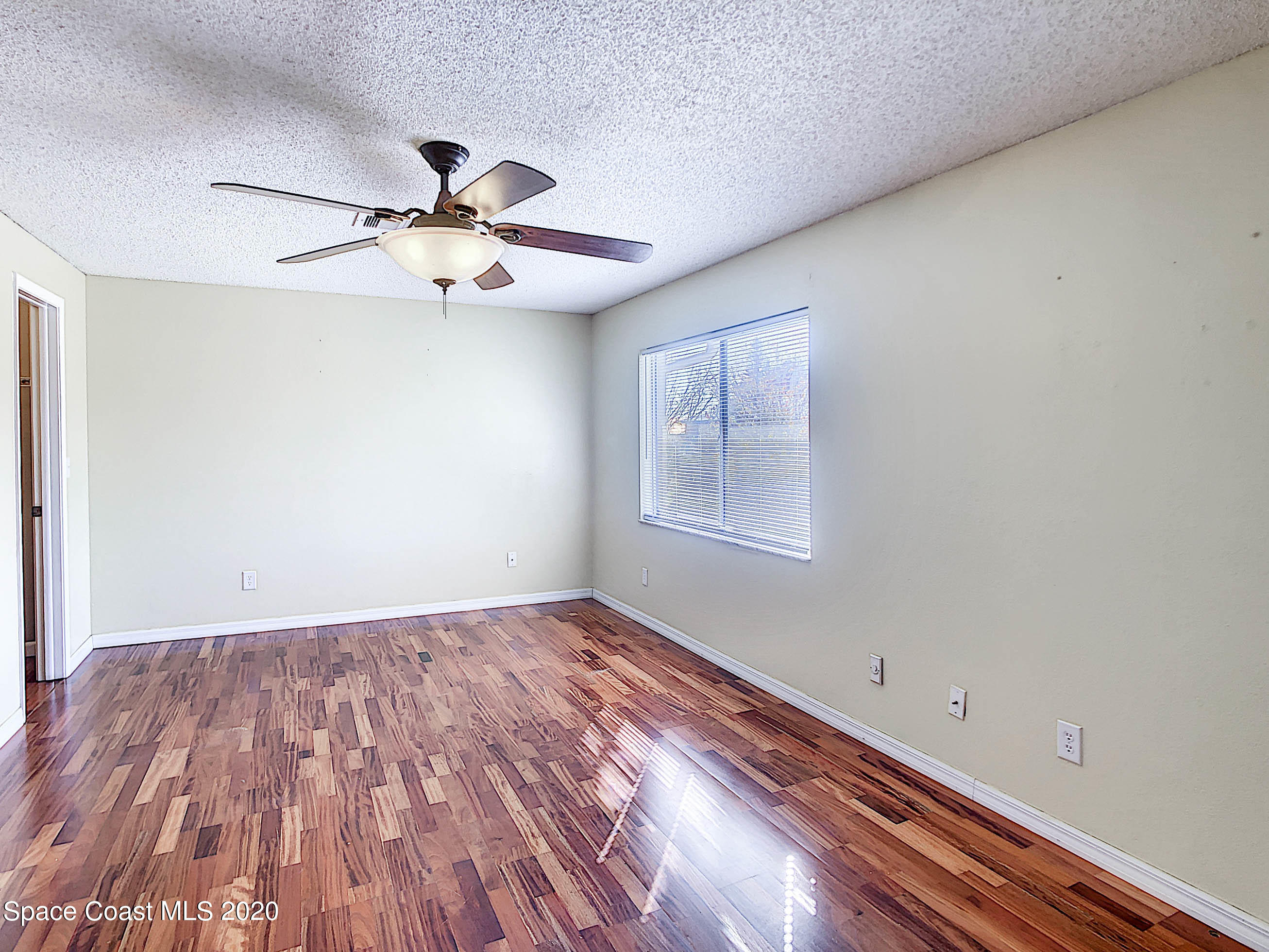 1882 Murrell Road, Unit 44 Rockledge, FL 32955 - Photo 10 of 27 wooden floor in an empty room with a window