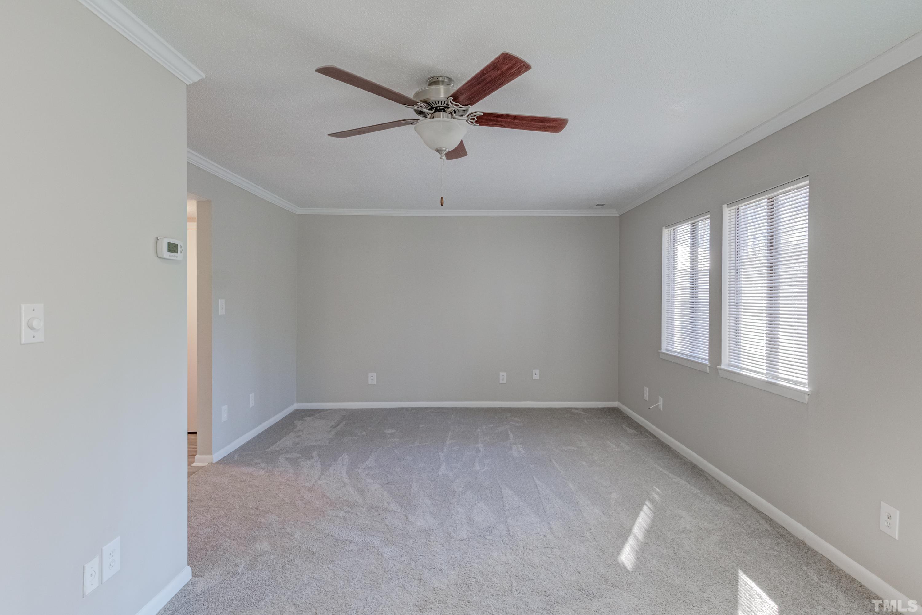 722 Godwin Court Raleigh, NC 27606 - Photo 21 of 41 an empty room with ceiling fan and windows