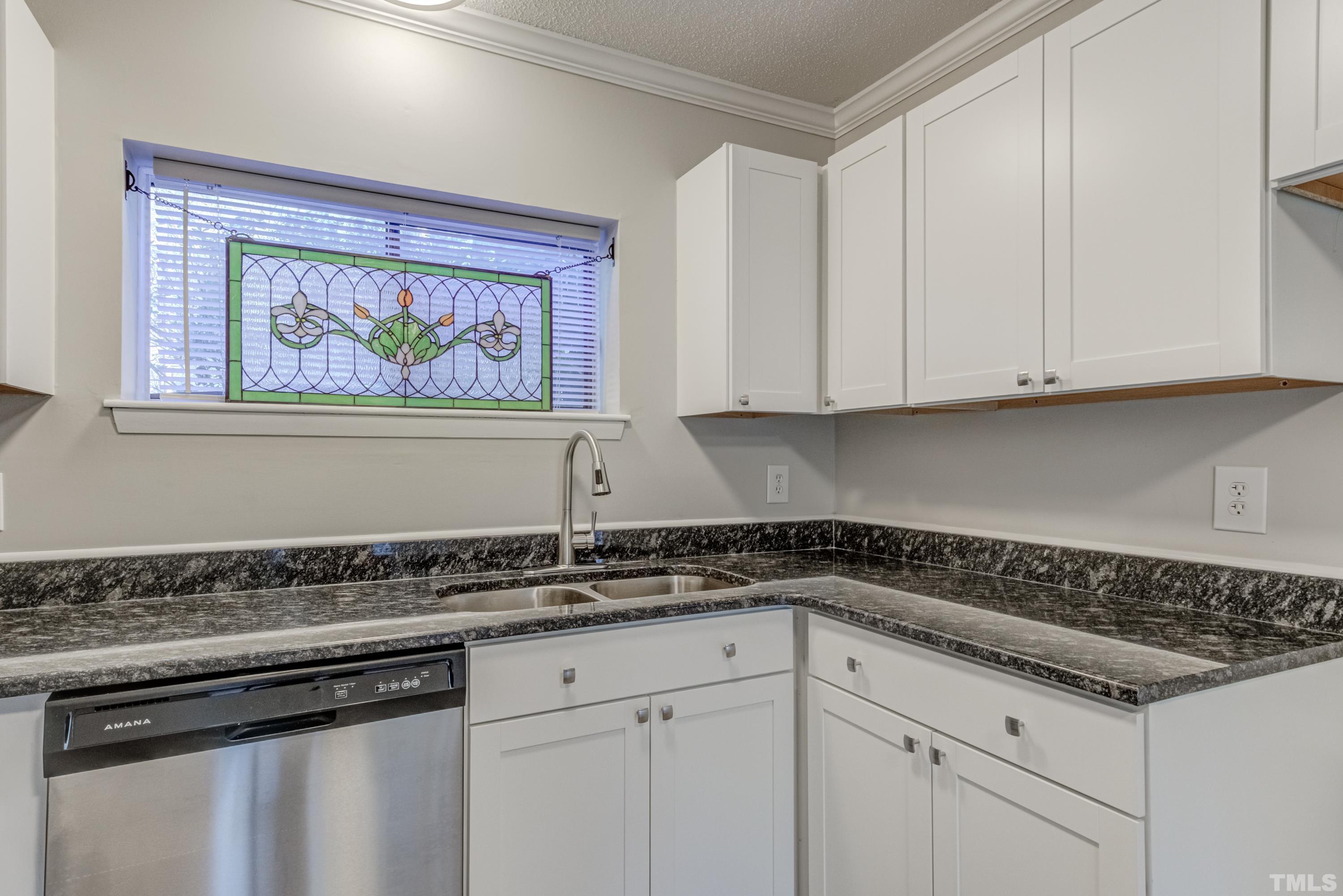 722 Godwin Court Raleigh, NC 27606 - Photo 31 of 41 a white kitchen with sink and cabinets