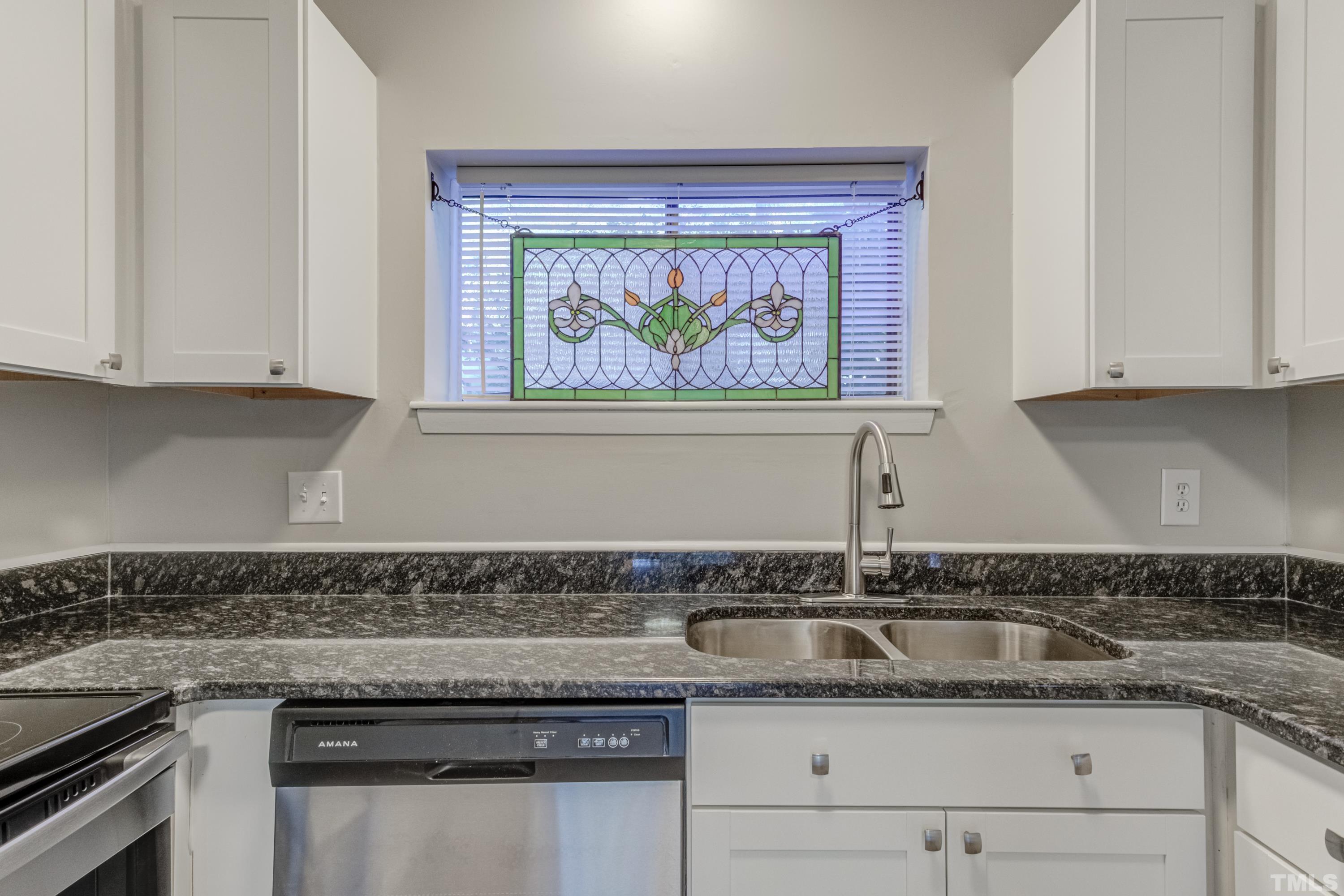 722 Godwin Court Raleigh, NC 27606 - Photo 32 of 41 a kitchen with granite countertop white cabinets and a stove
