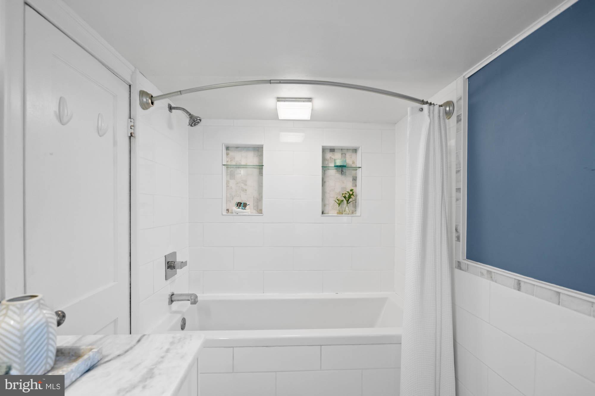 5305 Wakefield Road Bethesda, MD 20816 - Photo 54 of 87 a bathroom with a bathtub and a shower