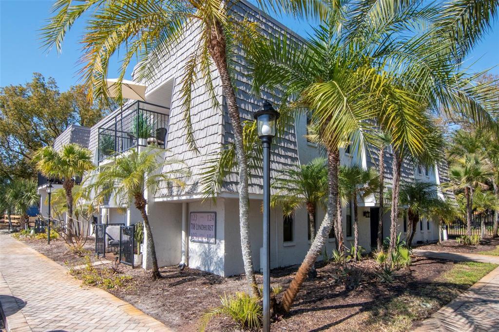 708 Lyndhurst Street, Unit 123 Dunedin, FL 34698 - Photo 1 of 1 a front view of a house with a yard