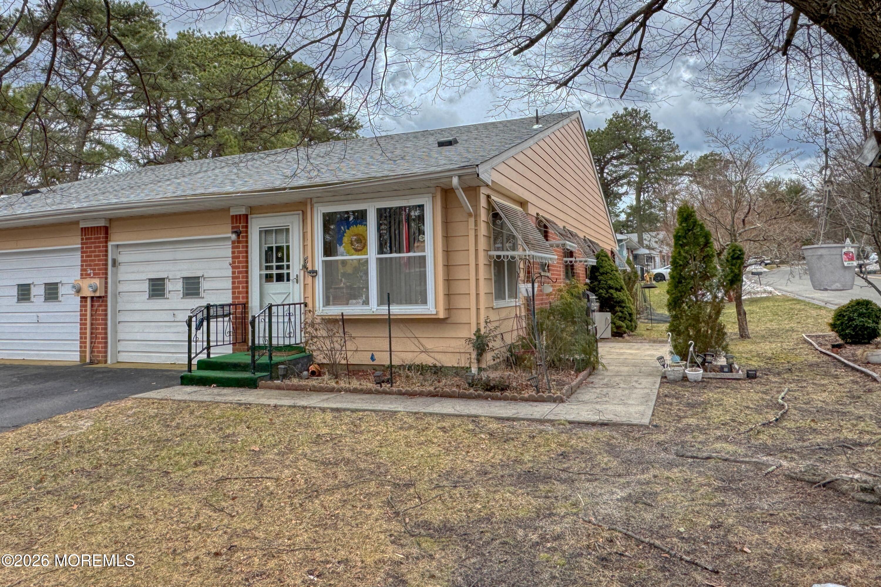 8 Lexington Drive, Unit B Whiting, NJ 08759 - Photo 1 of 11 a front view of a house with a yard