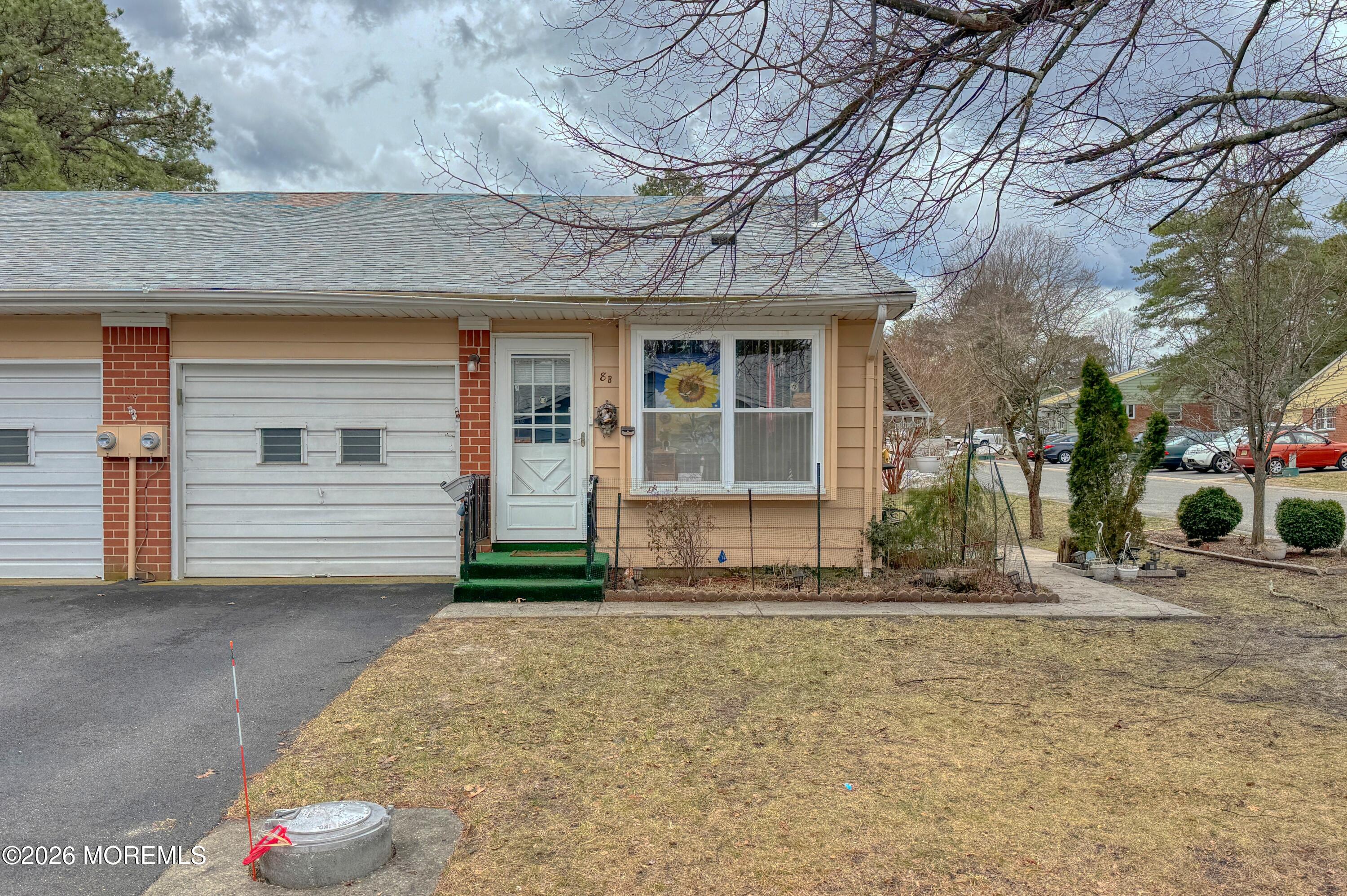 8 Lexington Drive, Unit B Whiting, NJ 08759 - Photo 11 of 11 a front view of a house with garden