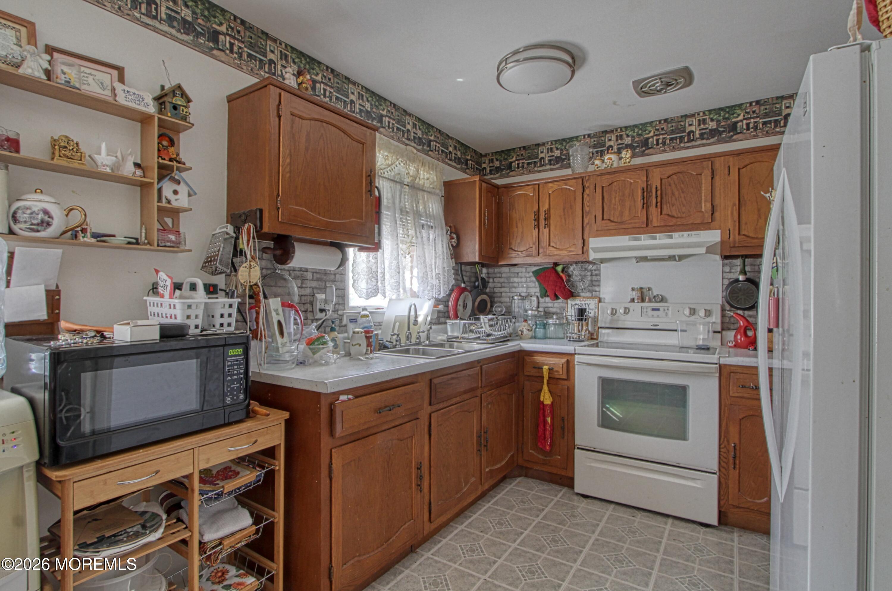 8 Lexington Drive, Unit B Whiting, NJ 08759 - Photo 2 of 11 a kitchen with a sink cabinets and stainless steel appliances