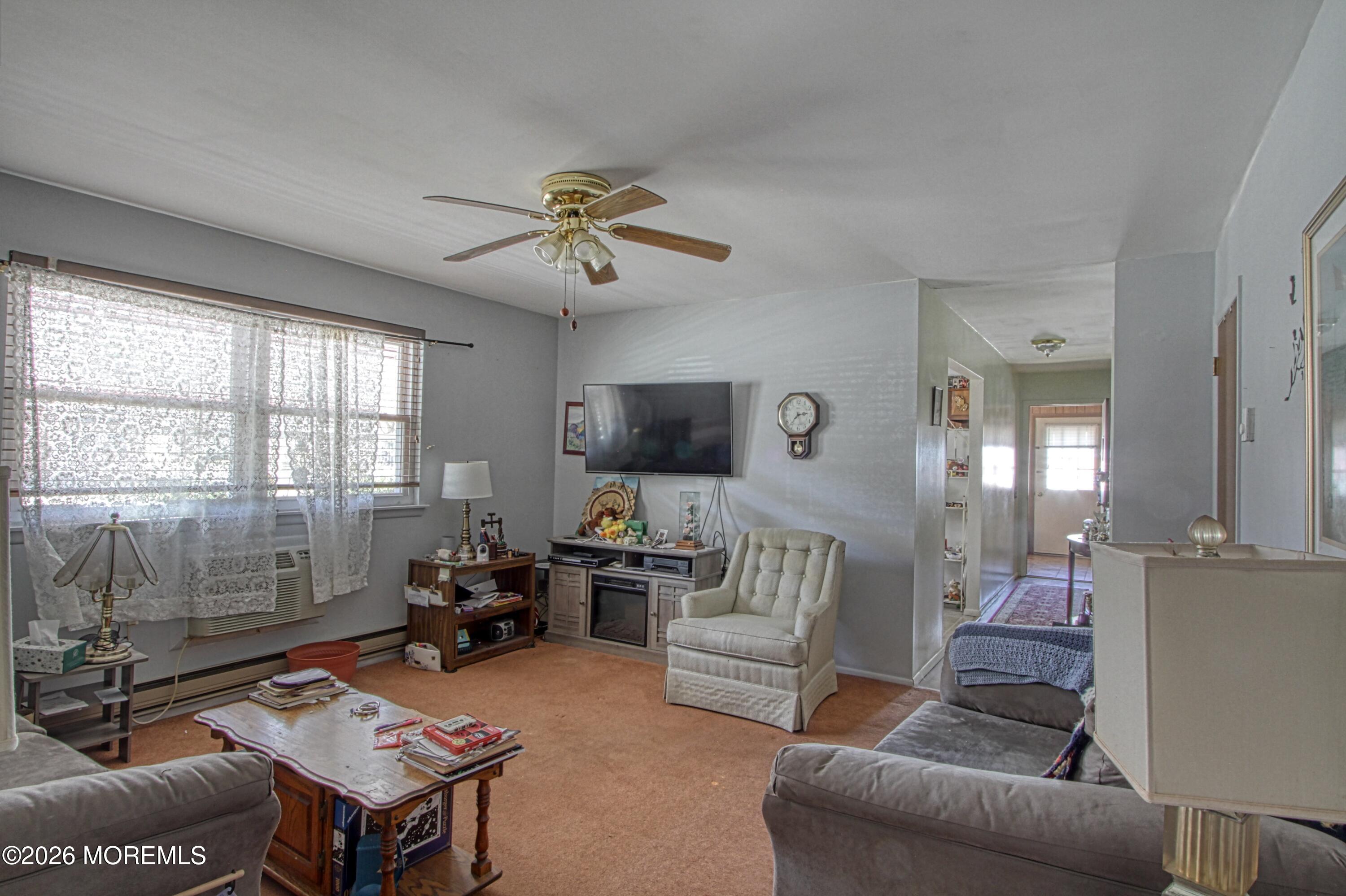 8 Lexington Drive, Unit B Whiting, NJ 08759 - Photo 4 of 11 a living room with furniture a chandelier and a window