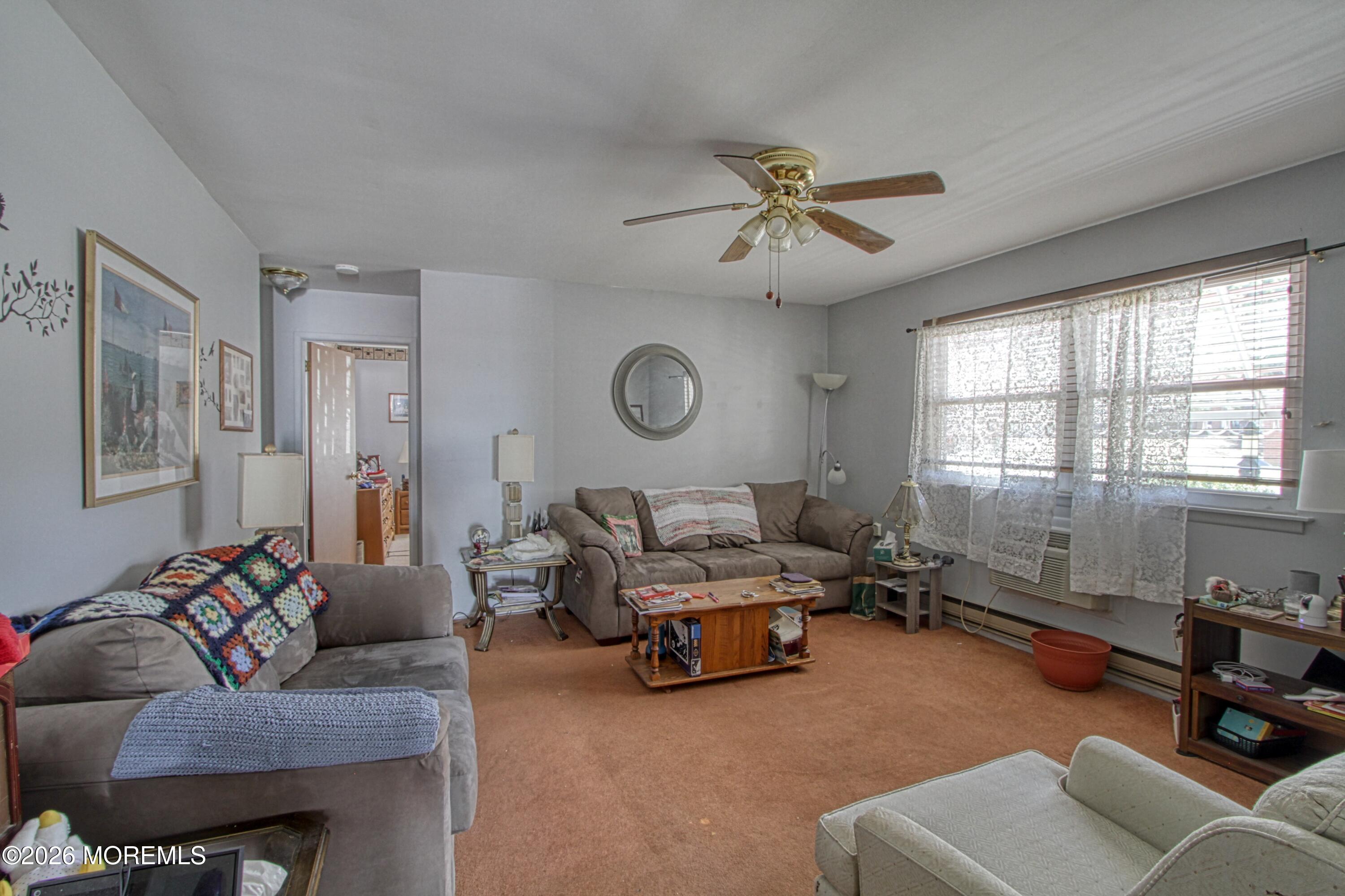 8 Lexington Drive, Unit B Whiting, NJ 08759 - Photo 5 of 11 a living room with furniture gym equipment and a large window