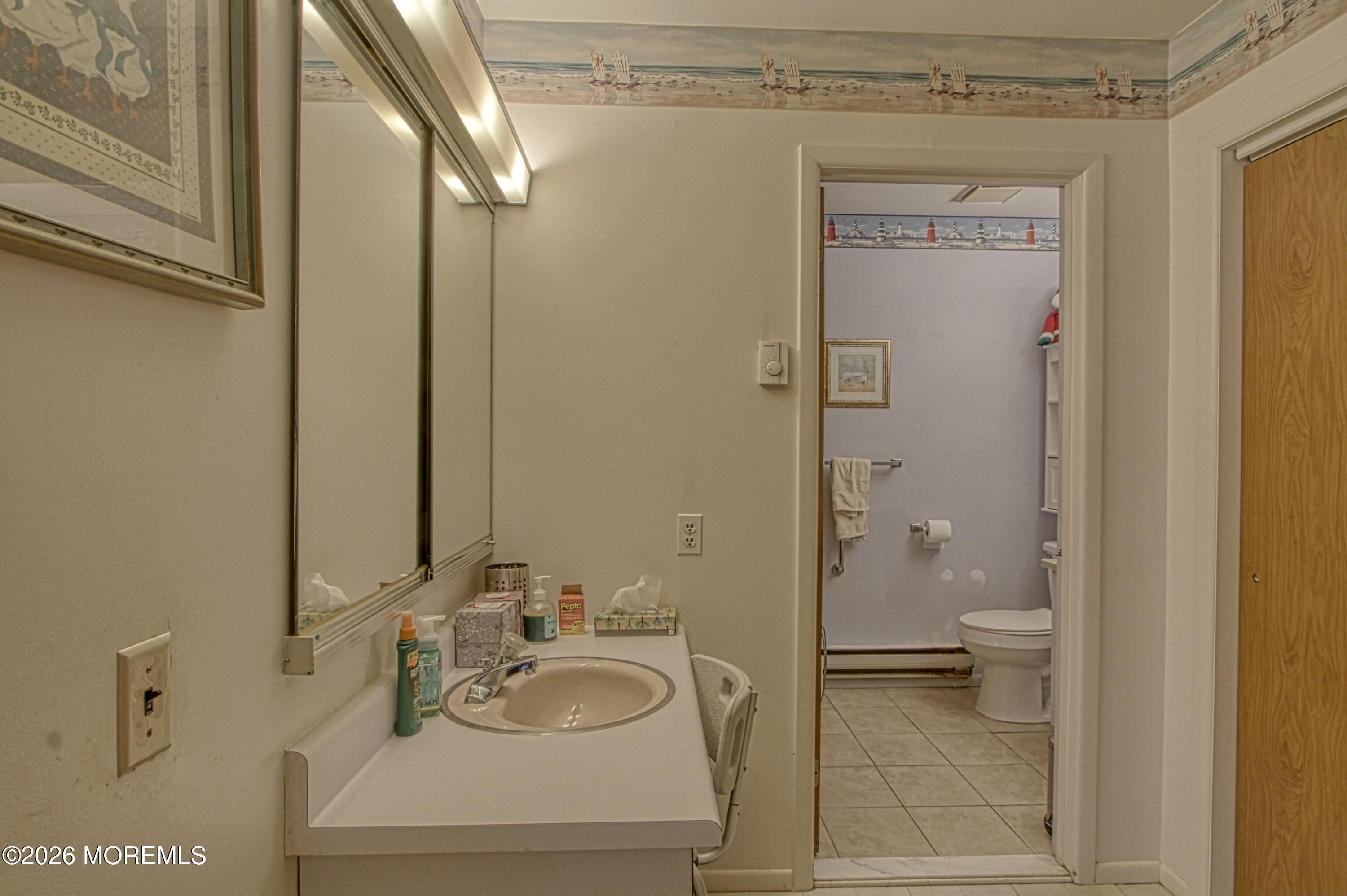 8 Lexington Drive, Unit B Whiting, NJ 08759 - Photo 6 of 11 a bathroom with a granite countertop sink toilet and shower