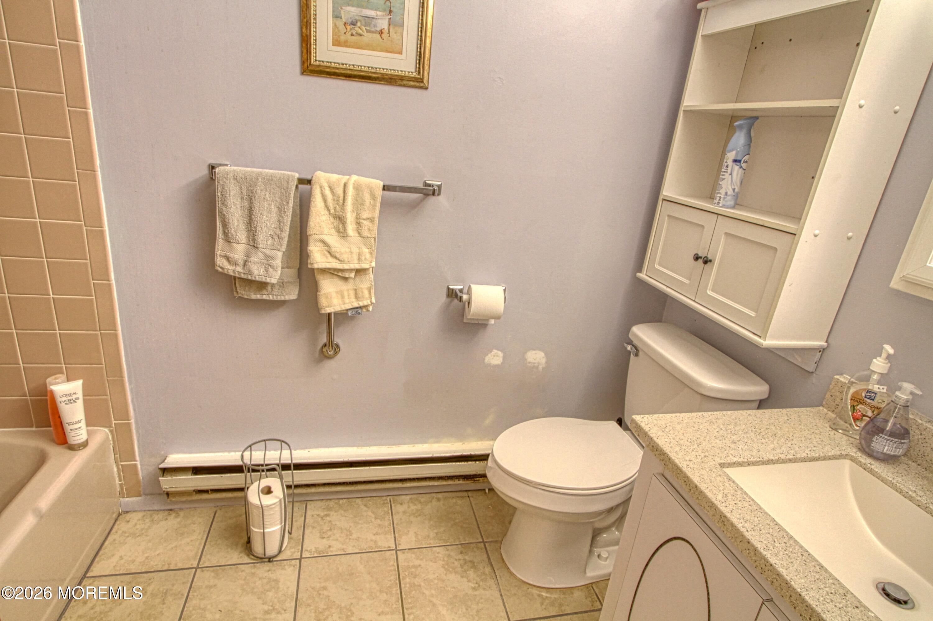 8 Lexington Drive, Unit B Whiting, NJ 08759 - Photo 7 of 11 a white toilet sitting next to a bathroom sink and a granite floor