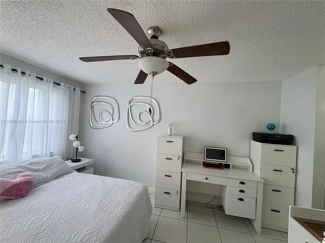a bedroom with a bed and a potted plant