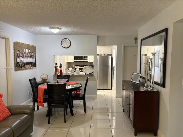 a view of a dining room with furniture and a large window