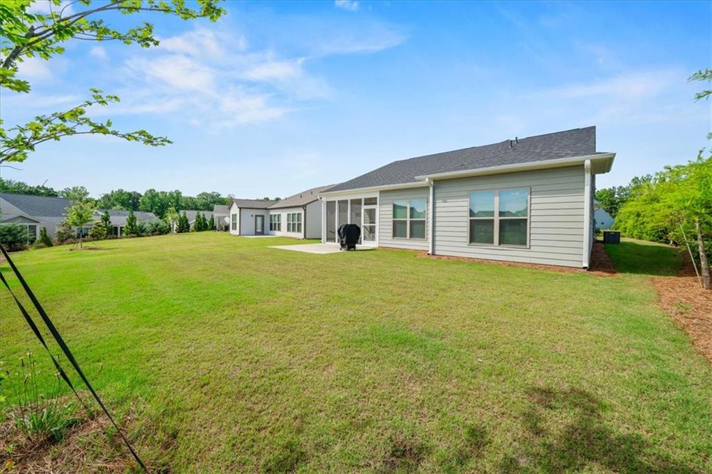 2457 Naples Street Hoschton, GA 30548 - Photo 34 of 41 a view of a house with a yard