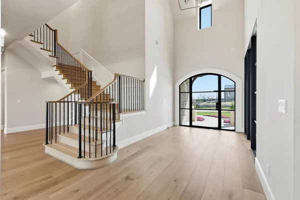 a view of a hallway with wooden floor and a window